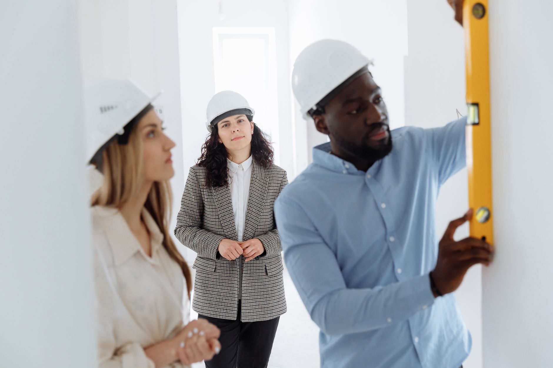 Project manager overseeing office fitouts with blueprint and risk management focus