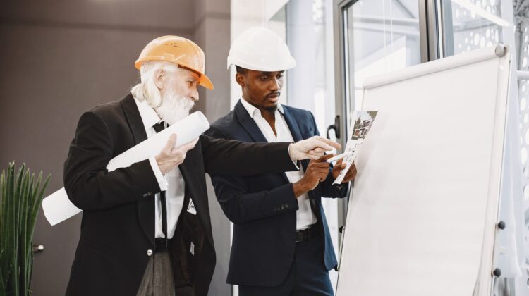 Project tracking in corporate office fitout planning with project manager reviewing progress