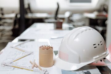 Workspace planning for corporate office fitouts with project manager reviewing blueprint