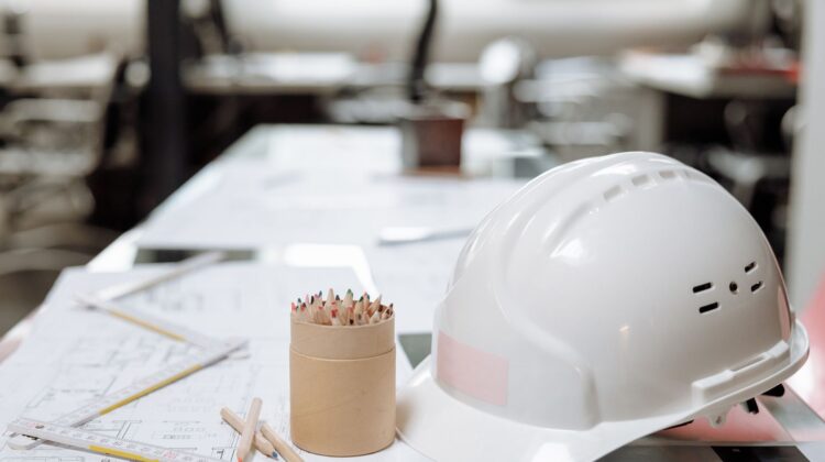 Workspace planning for corporate office fitouts with project manager reviewing blueprint
