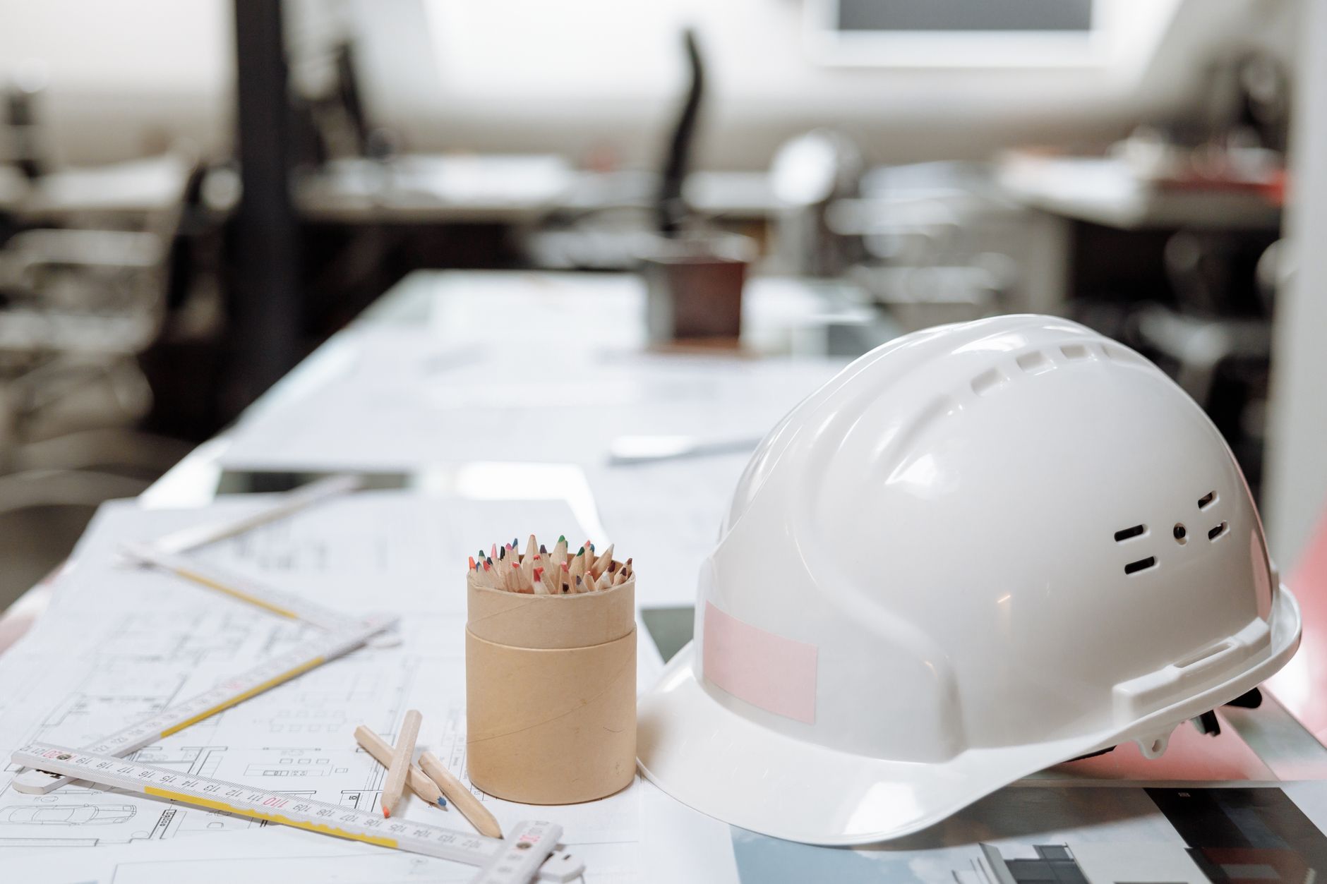 Workspace planning for corporate office fitouts with project manager reviewing blueprint