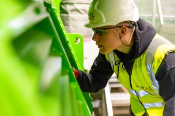 Project manager implementing construction strategy risk controls on site