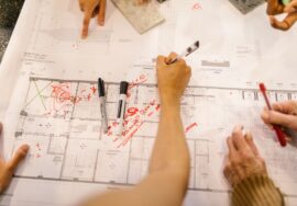 Construction project manager reviewing procurement planning documents on site
