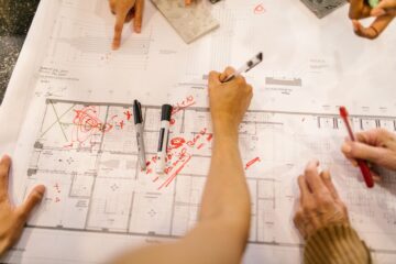 Construction project manager reviewing procurement planning documents on site