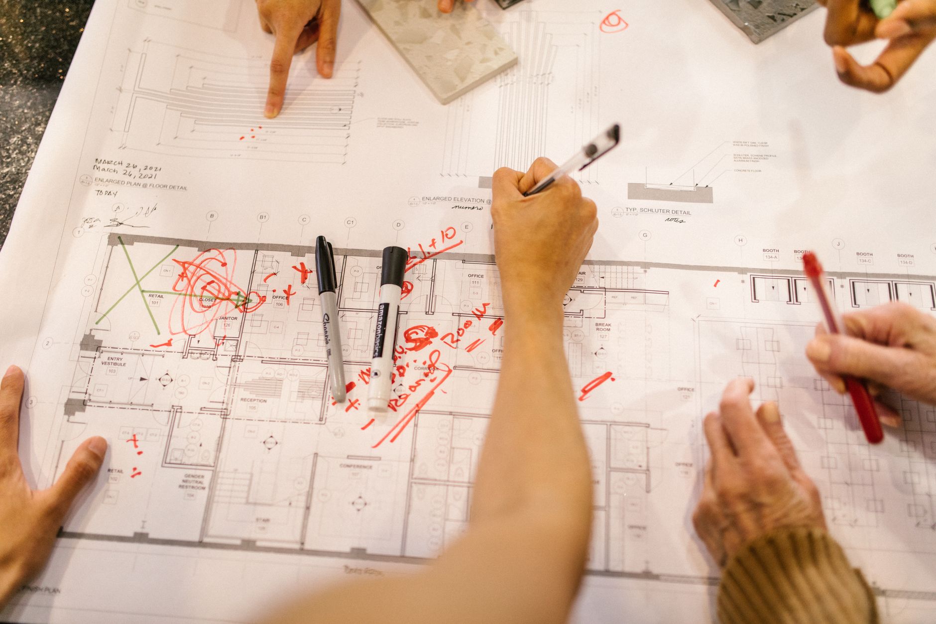 Construction project manager reviewing procurement planning documents on site