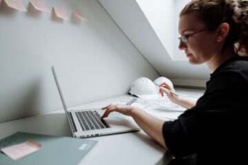 construction project manager reviewing scope management documents to control construction costs