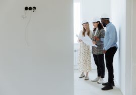Construction project manager using time management techniques reviewing blueprint on site