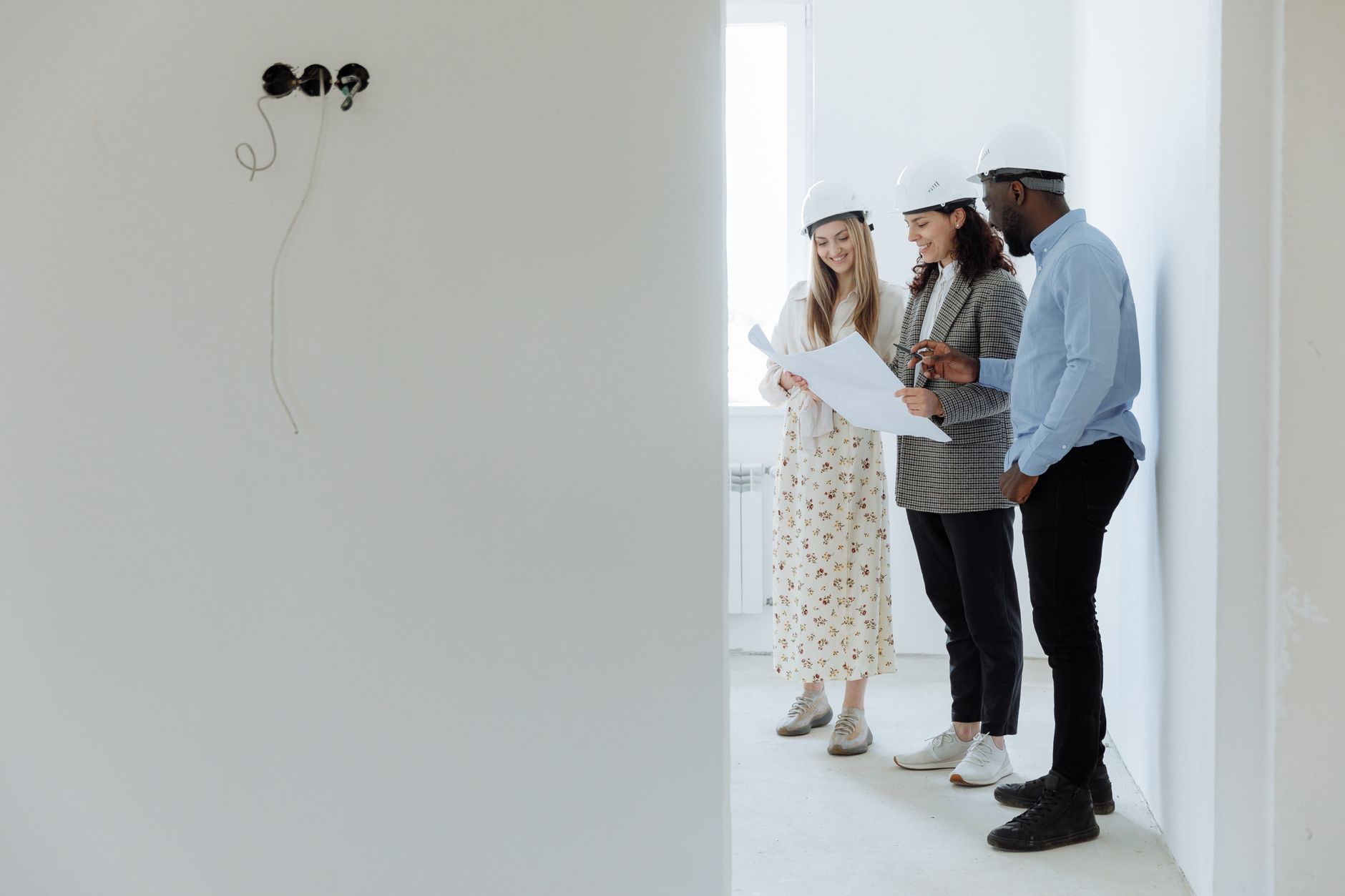 Construction project manager using time management techniques reviewing blueprint on site
