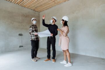 construction site with project manager reviewing safety planning checklist