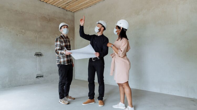 construction site with project manager reviewing safety planning checklist